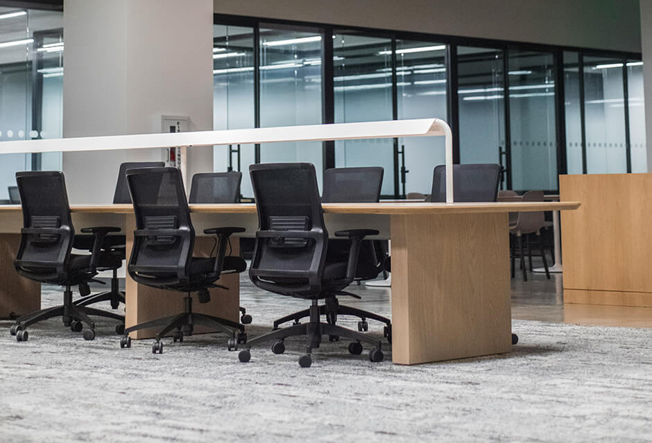 an office with a series of desks and chairs