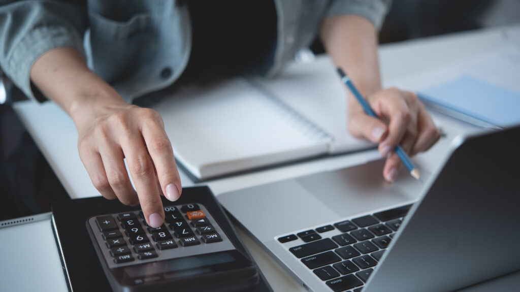 woman using calculator to calculate finances