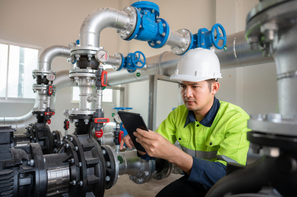 an industrial engineer works to inspect and maintain factory pipes or water systems in engineering plants, utilities, sewers and industrial wastewater treatment plants